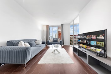 Bright and stylish living room with stunning city views from the heart of a modern high-rise