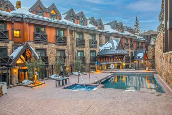 A resort with multiple buildings, outdoor pools, and a ski lift. - Luxury condo only 1 block to Bridge St. & slopes. Private hot tub free parking!! (Vail)