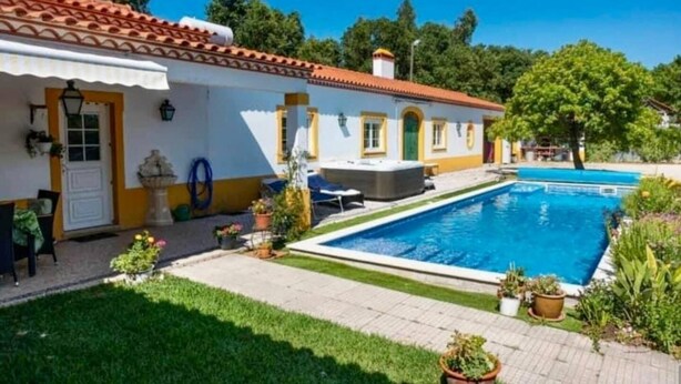 A two-story building with a swimming pool, a covered patio, and a well-maintained lawn. - Casa Vimeiro Sleeps 2 With Pets (Alcobaça)
