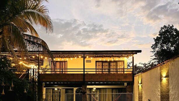 A two-story building with a swimming pool in front.