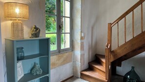 Un escalier avec des marches en bois et une rampe en bois, menant à l’étage supérieur.