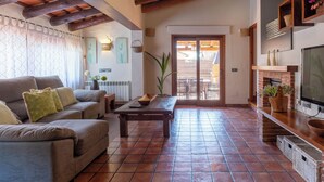 A living room with a sofa, coffee table, and a fireplace. - Bel House fantastic property located in the exclusive urbanization Res.Begur (CT)