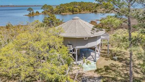A house with a covered porch and a view of a lake.