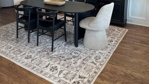 A dining area with a round table, black chairs, a chandelier, a mirror, and a patterned rug. - Charming 5-bedroom Masters Rental house in River Oaks  in quaint Evans (Evans)