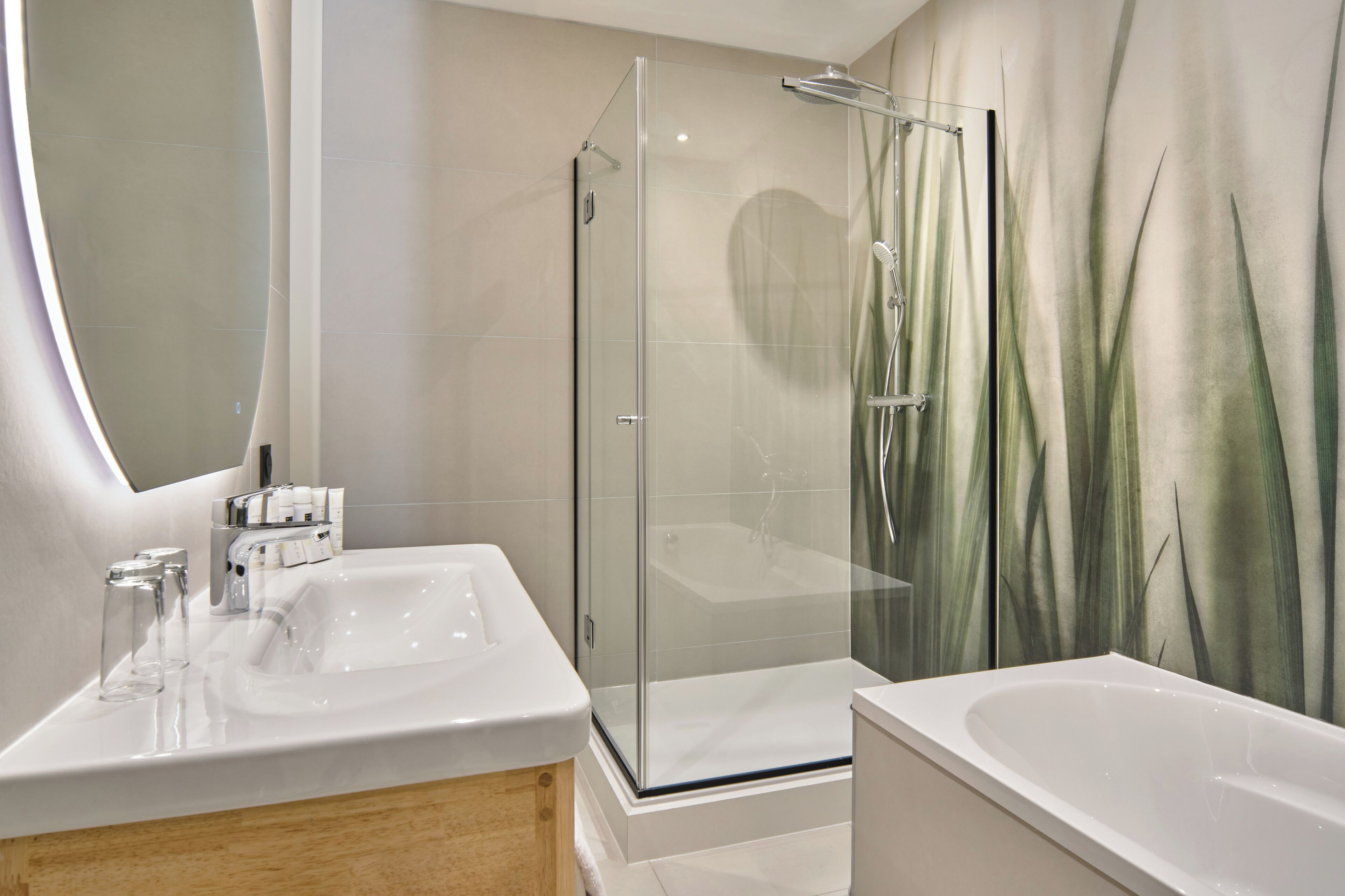A modern bathroom with a glass-enclosed shower, a large mirror, and a bathtub.