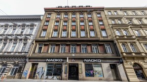 A building with the 'NAOKO' sign, featuring a classical architectural style with multiple windows and a prominent entrance. - Prague Legends Pension (Prague)