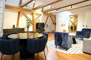 Senior Loft | Living area | 48-inch flat-screen TV with digital channels, books, heated floors