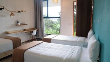 Deluxe Triple Room, Patio, City View | In-room safe, desk, laptop workspace, blackout drapes