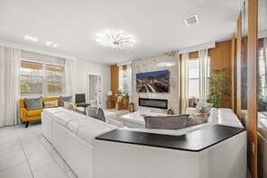 TV, fireplace - Modern Luxury at Disney’s Doorstep: Stunning 6BR/6BA Villa at Champions Gate! (Four Corners)