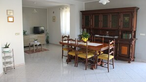 A dining area with a wooden table and chairs, a television, and a cabinet. - Apartment in the heart of Val di Sangro, between Costa dei Trabocchi and Majella. (Piazzano-piana La Fara)
