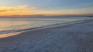 A beach with a clear sky and calm sea.