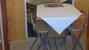 A small table with a white tablecloth, two chairs, and a menu on the table. - ROOMS MATEA PULA (Vodnjan)