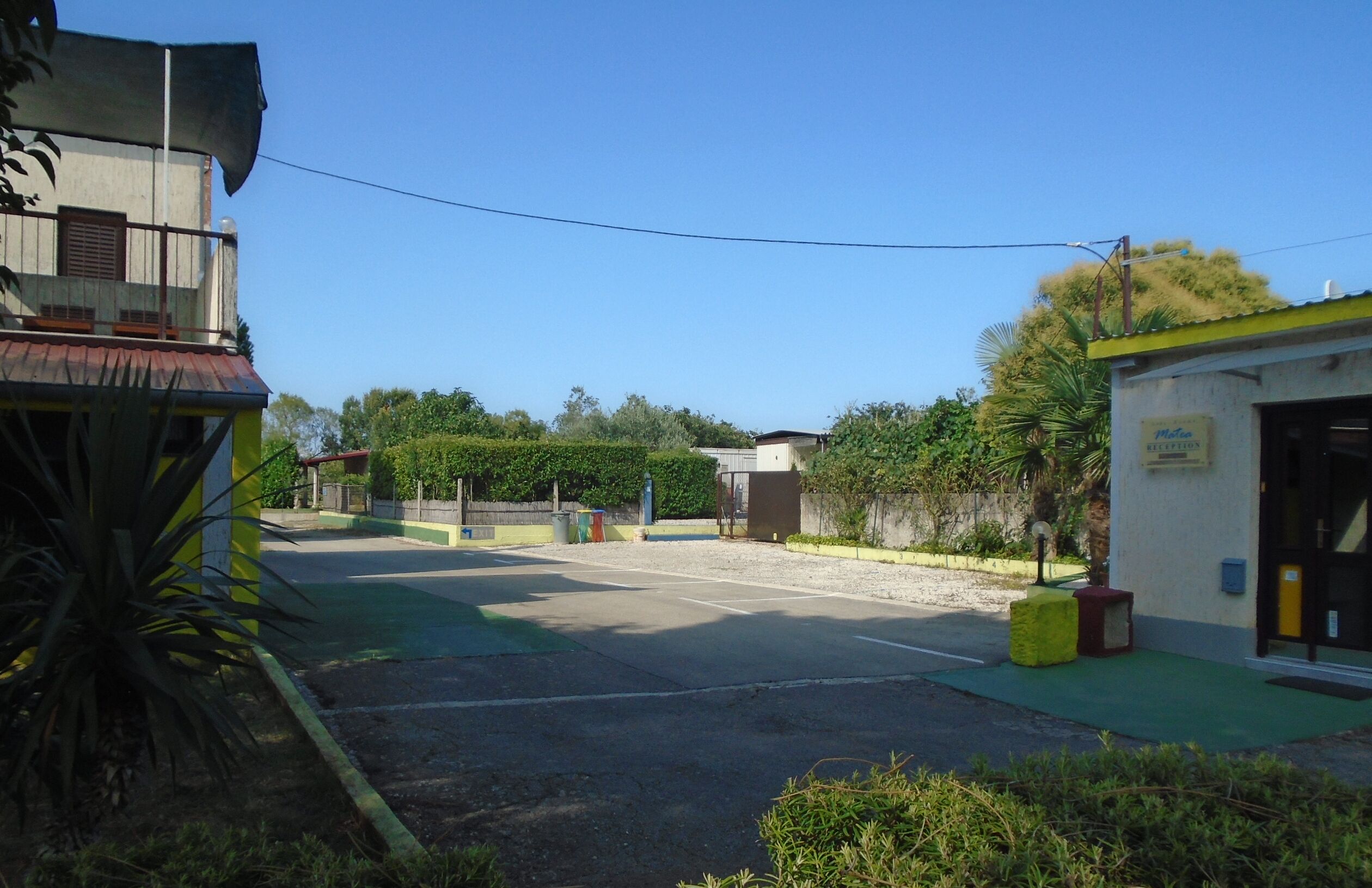 A quiet street with a small building that appears to be a hotel or guesthouse.