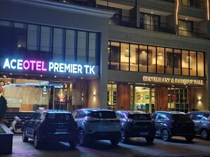 A hotel with a prominent sign reading "ACEOTEL PREMIER T.K" and a restaurant named "RESTAURANT & BANQUET HALL" adjacent to it. - Aceotel Premier TK Morbi (Morbi)