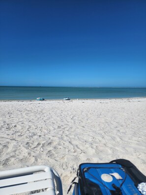 A beach with a clear sky, a sandy shore, and a blue water body in the distance. - Charming Vintage Beach Trailer Outside Sanibel Island LOCATION LOCATION LOCATION (Fort Myers)
