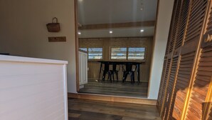 A staircase leading to a dining area with a wooden floor and a view of the dining space.