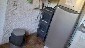 A compact kitchen with a refrigerator, a trash bin, and a water dispenser on the wall. - Country house for rent in 7700 St-Marcel d'Ardèche (Saint-Marcel-d'Ardèche)