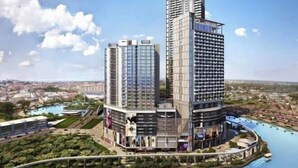 A modern high-rise hotel with multiple floors, a rooftop pool, and a surrounding landscaped area. - Shore Hotel Melaka Private Suites (Melaka)