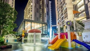 A water play area with slides and a water fountain, surrounded by tall buildings. - Shore Hotel Melaka Private Suites (Melaka)