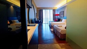 A hotel room with a bed, a desk, and a view of the outdoors. - Shore Hotel Melaka Private Suites (Melaka)