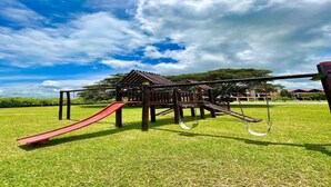 Un parque infantil con un tobogán y estructuras para escalar.