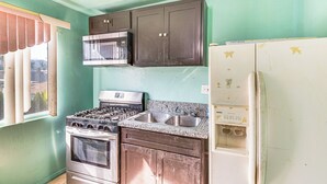 A kitchen with a gas stove, microwave, double sink, and a refrigerator. - 8 Mi to Dtwn LA: Apt w/ Shared Patio! (Los Angeles)
