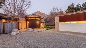 A house with a circular structure, a garage, and a mountainous backdrop. - River Spirit- Arquitectural wonder of the Sequoias (Three Rivers)