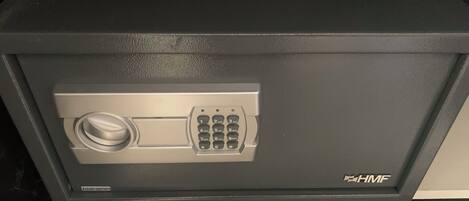 A safe deposit box with a combination lock and a keyhole.