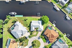 A residential area with houses, a swimming pool, and a marina with boats.