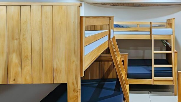 A bunk bed room with wooden walls and a tiled floor. - RedDoorz near Baguio Night Market (Baguio)