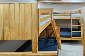 A bunk bed room with wooden walls and a tiled floor. - RedDoorz near Baguio Night Market (Baguio)