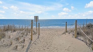 A sandy beach path leading to the ocean with wooden posts and ropes. - Practically Perfect on West Beach - Just steps away from the Atlantic Ocean (Oak Island)
