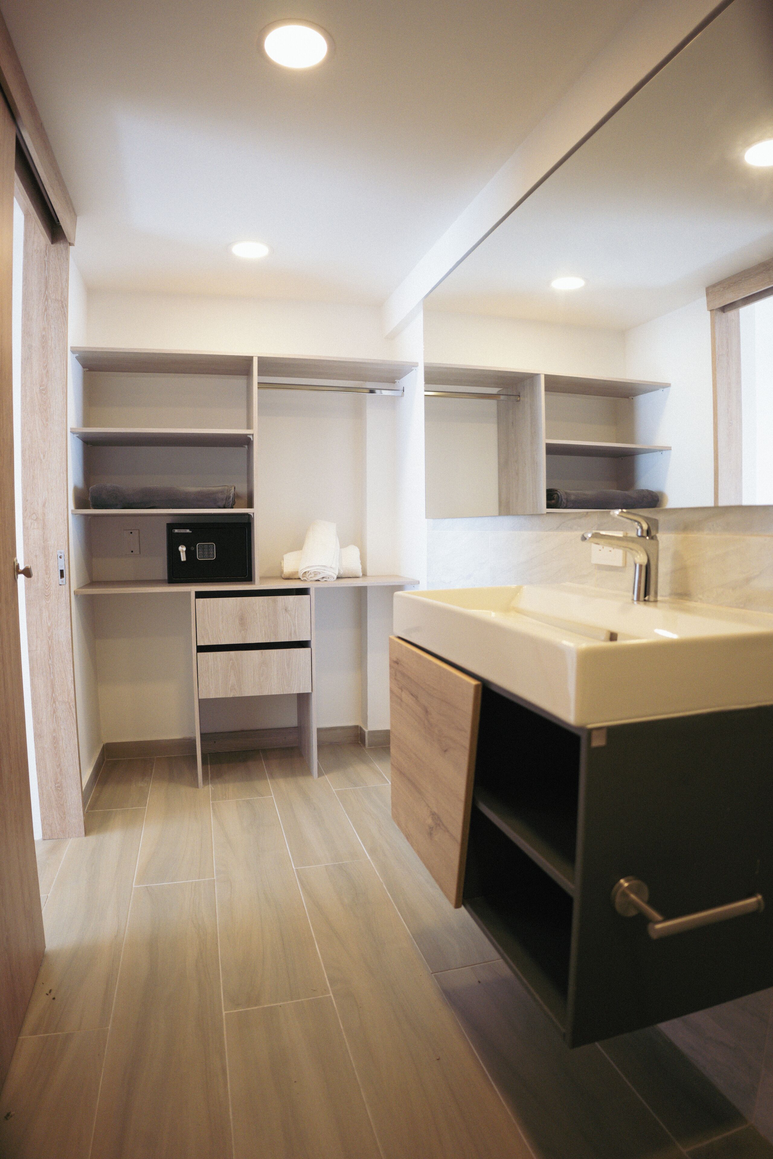 A modern kitchen with a built-in sink, a small countertop, and a storage cabinet.