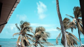 On the beach, white sand, beach umbrellas, beach towels