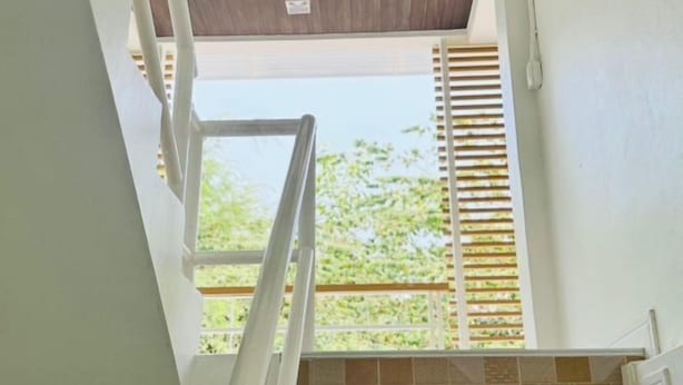 A view of a room with a window, a wooden ceiling, and a tiled wall. - Saengcanthr (Nakhon Ratchasima)