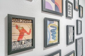 A wall with multiple framed artworks. - Room 105 - Two Queens - Kitchenette - NonSmoking (Lincoln)