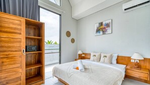 A modern bedroom with a large bed, wooden wardrobe, and a view of the outdoors. - Cozy 3bedroom villa Bliss, Close to Canggu,
King bed,Tranquil! (Bali)