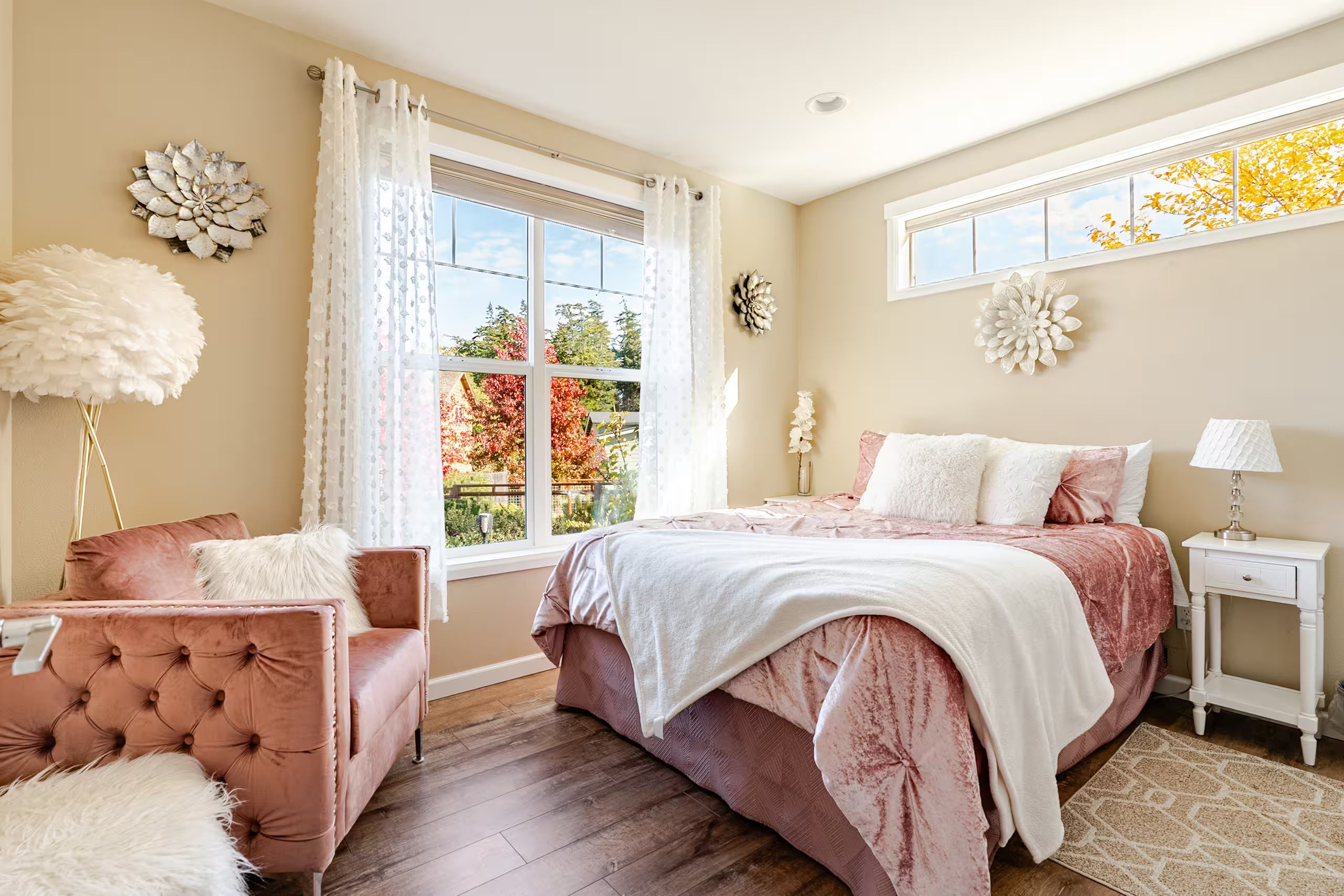 The second bedroom features a queen size bed and room darkening shades on the transom window and the large window that looks out to beautifully landscaped backyard.