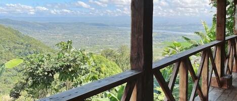 A wooden deck with a view of a mountainous landscape.