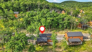 A residential area with houses surrounded by dense greenery and hills. - Private Hot Tub & Indoor Pool Cabin, Steps to Pond, Free Daily Tickets Near Thunder Ridge (Hollister)