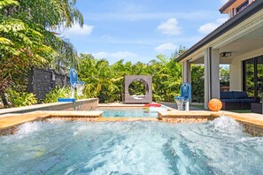 A hot tub with a basketball hoop and a small pool. - Themed Glow Villa • 4K Cinema • Heated Pool • Lake • Sleeps 12 (Miami)
