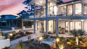 A modern two-story house with a balcony, large windows, and a landscaped garden. - 5 BDR - 250m to Beach - Outdoor Spa - Book 3 Nights, Pay for 2 until 24 September 2026 (Hyams Beach)