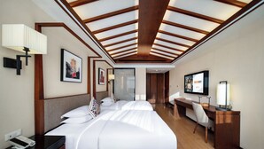 A hotel room with a large bed, a desk, and a television. - SSAW Boutique Hotel Hangzhou Qianjiang New City Jinjiang Subway Station Branch (Hangzhou)