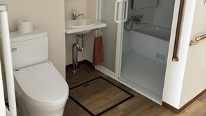 A modern bathroom with a toilet, sink, and shower. - SakuraMandarin (Sakura)