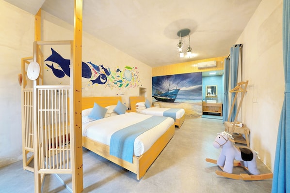 A hotel room with two beds, a wooden crib, a rocking horse, and a mural of a boat on the wall. - Pingtan Travel Notes Cat Head (Fuzhou)