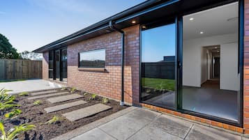 Stunning garden views from the large glass doors lead to a modern interior with a flat roof.