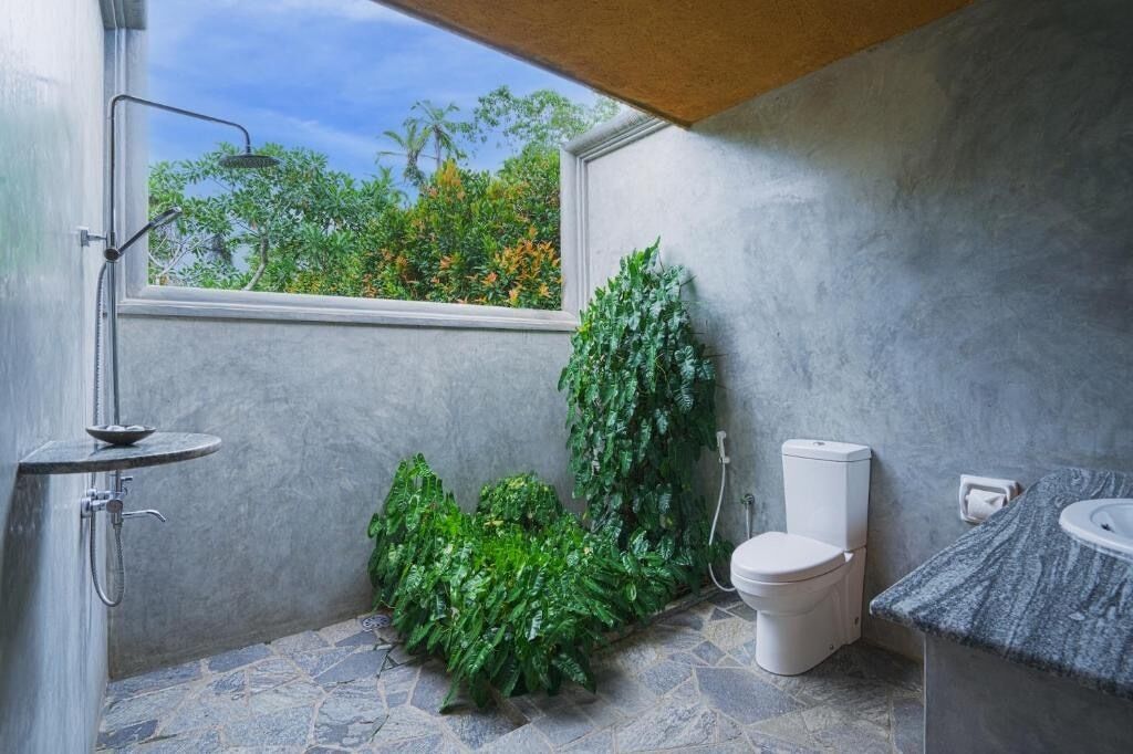 A bathroom with a shower, toilet, and sink.