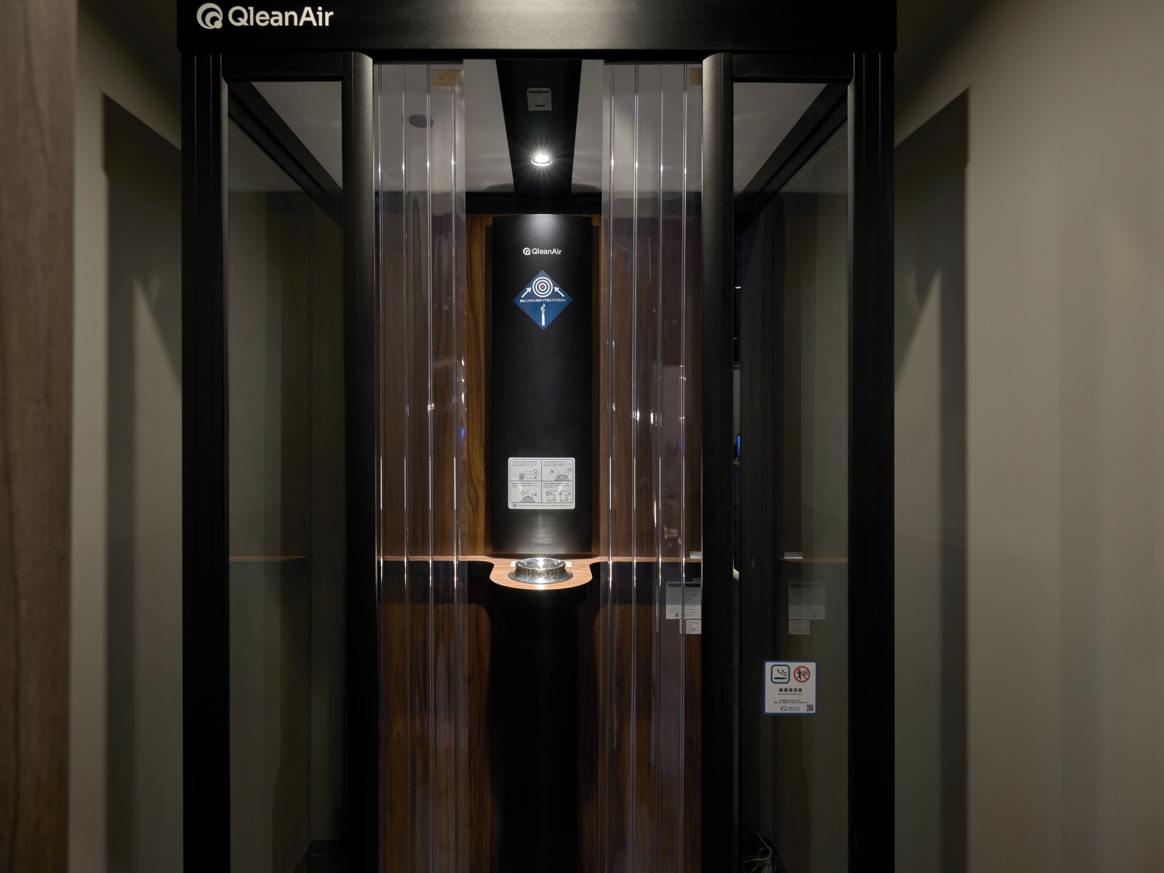 An elevator with a ClearAir logo, control panel, and a sign indicating no smoking.