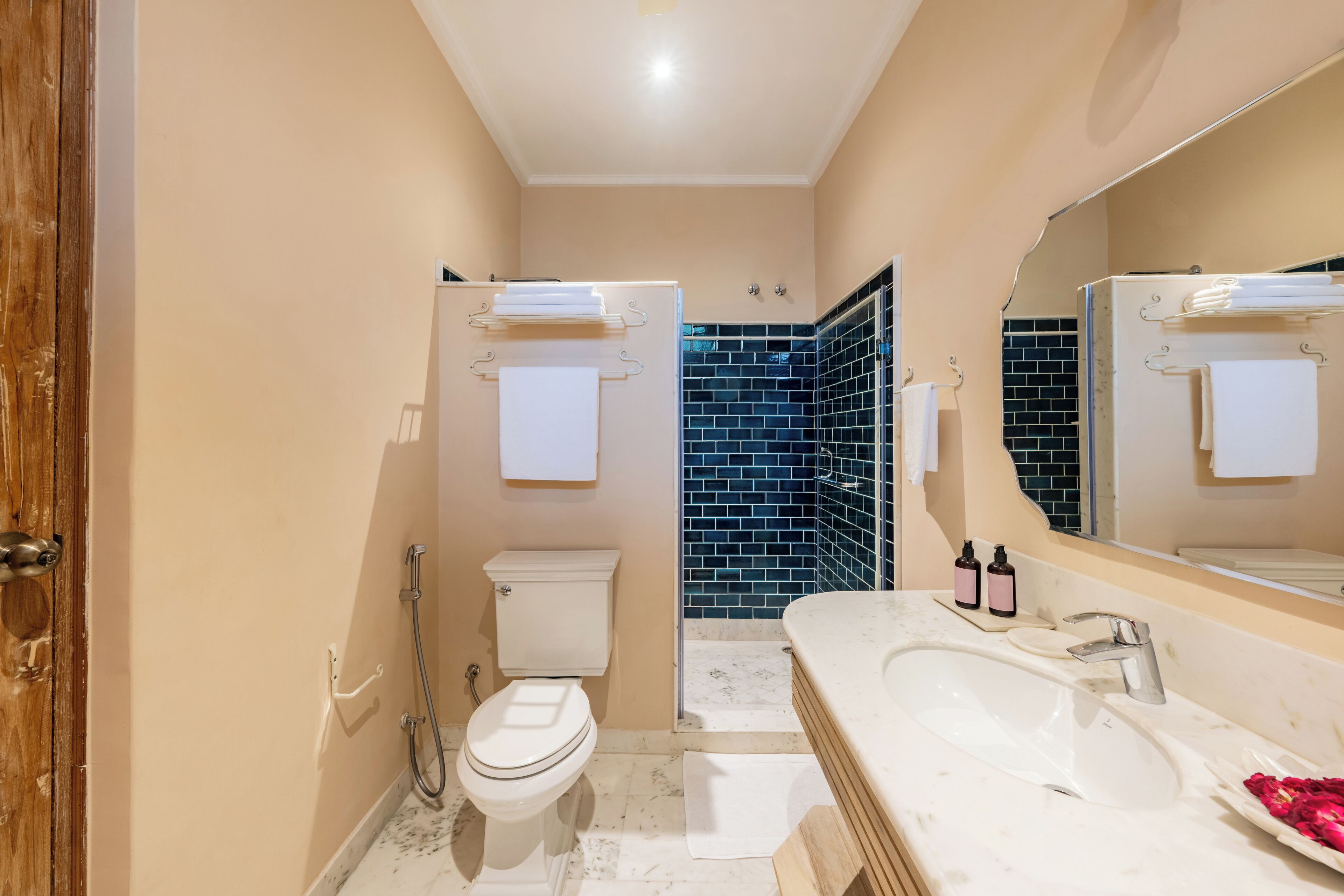 A bathroom with a toilet, sink, and shower area.