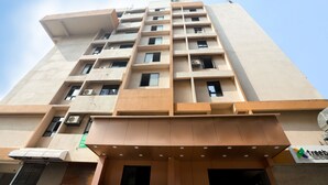 A multi-story building with a modern architectural design, featuring a flat roof, numerous windows, and a sign indicating a business or commercial use. - Hotel BKC Minerva  (Mumbai)